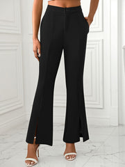 Black tailored flare trousers with split hems and a high waist.
