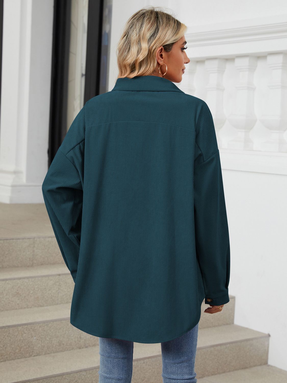 Oversized corduroy shirt jacket in dark navy with buttoned cuffs and a relaxed fit.