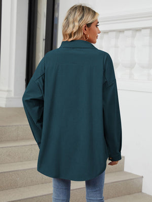Oversized corduroy shirt jacket in dark navy with buttoned cuffs and a relaxed fit.