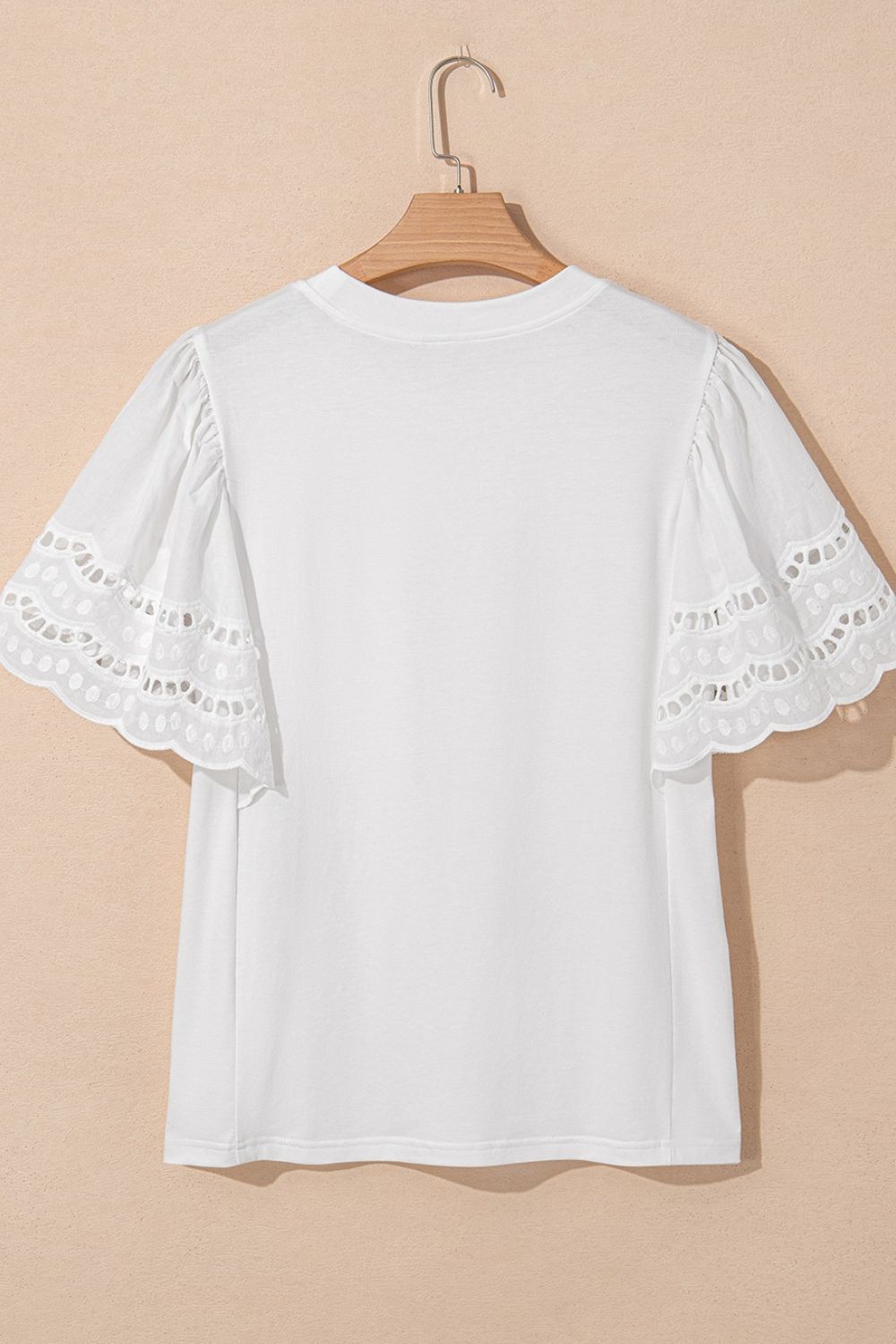 White cotton t-shirt with short flutter sleeves featuring eyelet lace trim and scalloped edges.