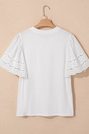 White cotton t-shirt with short flutter sleeves featuring eyelet lace trim and scalloped edges.