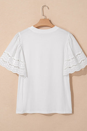 White cotton t-shirt with short flutter sleeves featuring eyelet lace trim and scalloped edges.