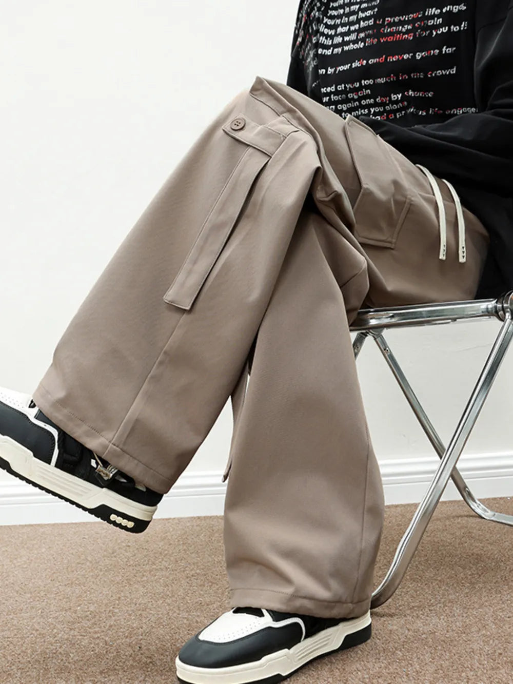 Light brown cargo pants with drawstring and button flap pockets.