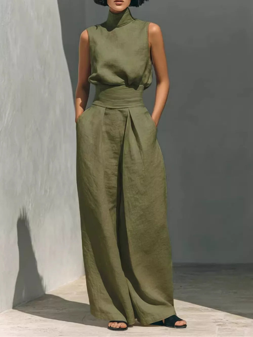 Army green sleeveless turtleneck and wide-leg pants set with belted waist.