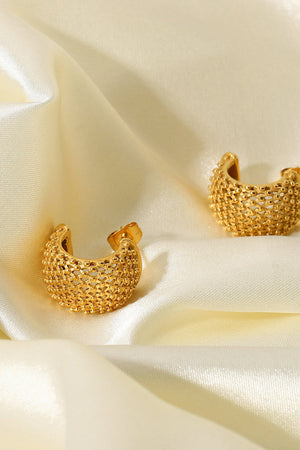 Textured gold crescent earrings with a beaded pattern.