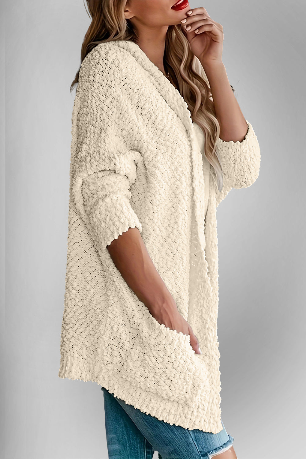 Cream popcorn knit open cardigan with pockets, 3/4 sleeves, and textured detail.