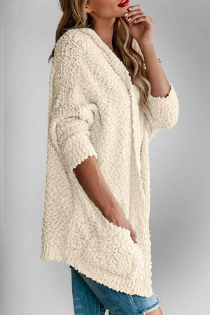 Cream popcorn knit open cardigan with pockets, 3/4 sleeves, and textured detail.