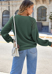 Green waffle knit raglan top with lace yoke detail and long sleeves.