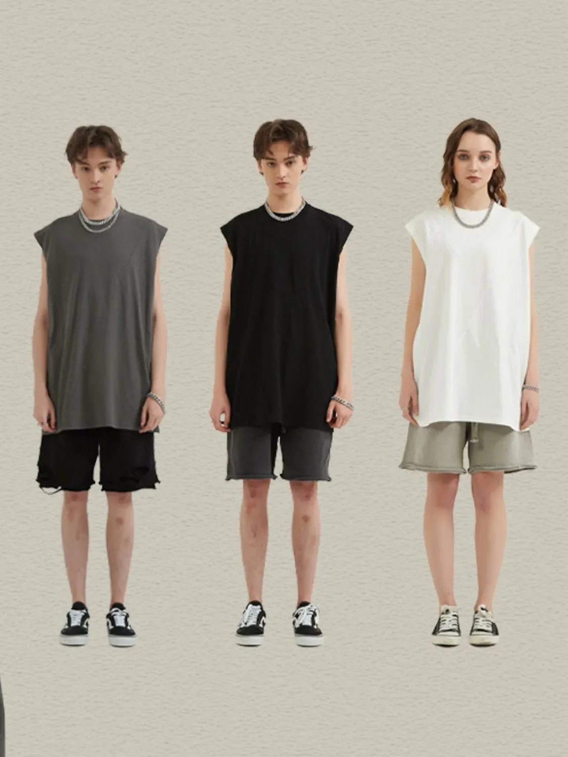 Sleeveless asymmetric panel tank top in black, white, or dark gray. Casual, bold style.