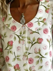 Peter Pan collar blouse with floral print, button-down front, and delicate pink roses.