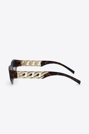Tortoiseshell cat-eye sunglasses with gold chain detail on the temples.