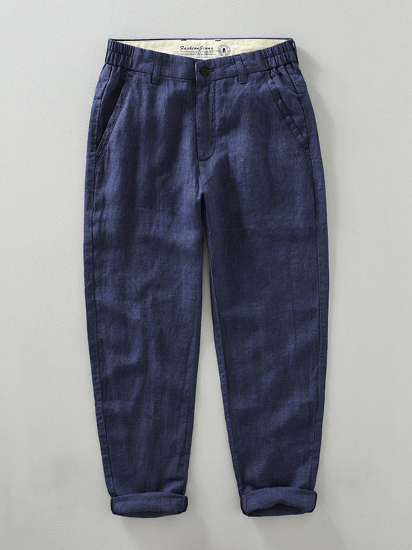 Blue linen cropped sweatpants for men with elastic waistband and cuffed hems.
