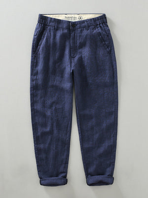 Blue linen cropped sweatpants for men with elastic waistband and cuffed hems.