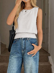 White smocked waist relaxed fit tank top with crew neck and sleeveless cut.