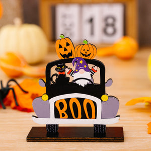 Halloween gnome car tableau with black cat, pumpkins, and "BOO" text.