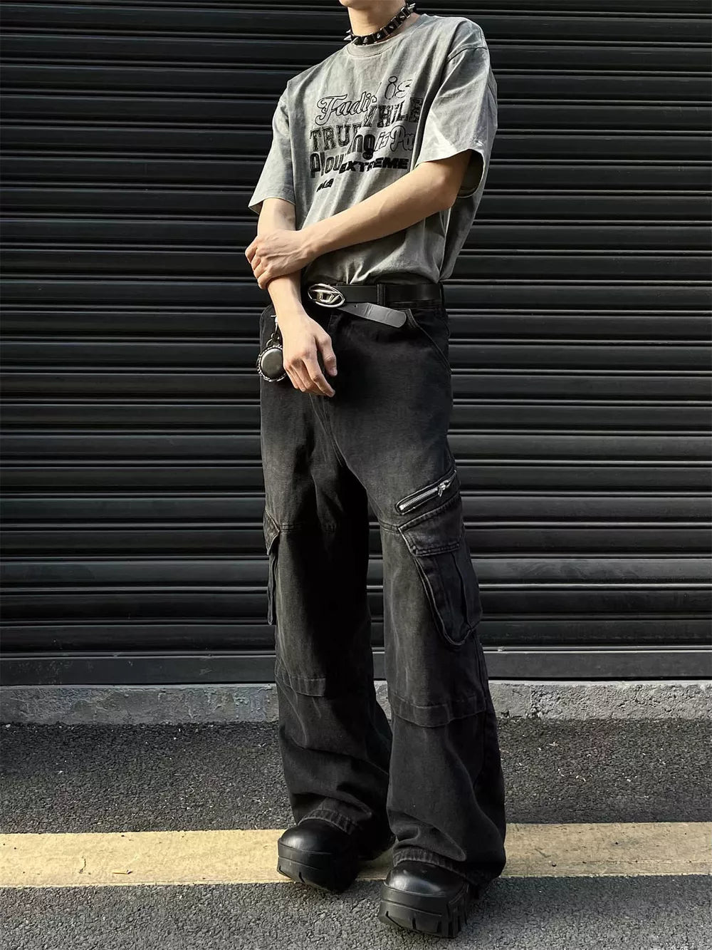 Men's oversized vintage black denim cargo pants with zippered pockets.