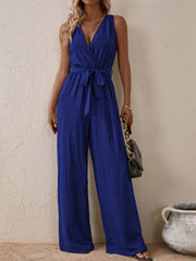 Textured wrap-front wide-leg jumpsuit in indigo with a self-tie belt.
