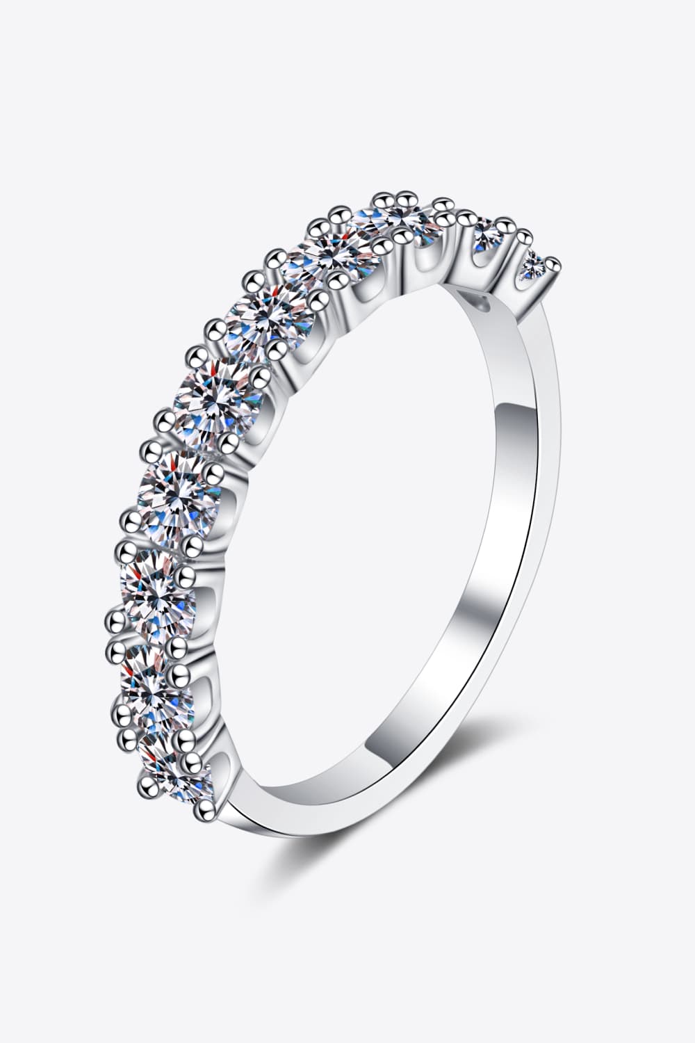 Silver eternity band ring with a row of brilliant moissanite stones.