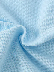 Light blue cotton skort fabric detail, showing textured weave.