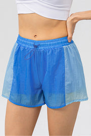 Colorblock performance running shorts in blue with drawstring waist and breathable fabric.