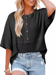 Black waffle-knit t-shirt with button detail and textured hem.