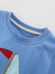 Blue cotton t-shirt with sailboat graphic and cream neck trim.