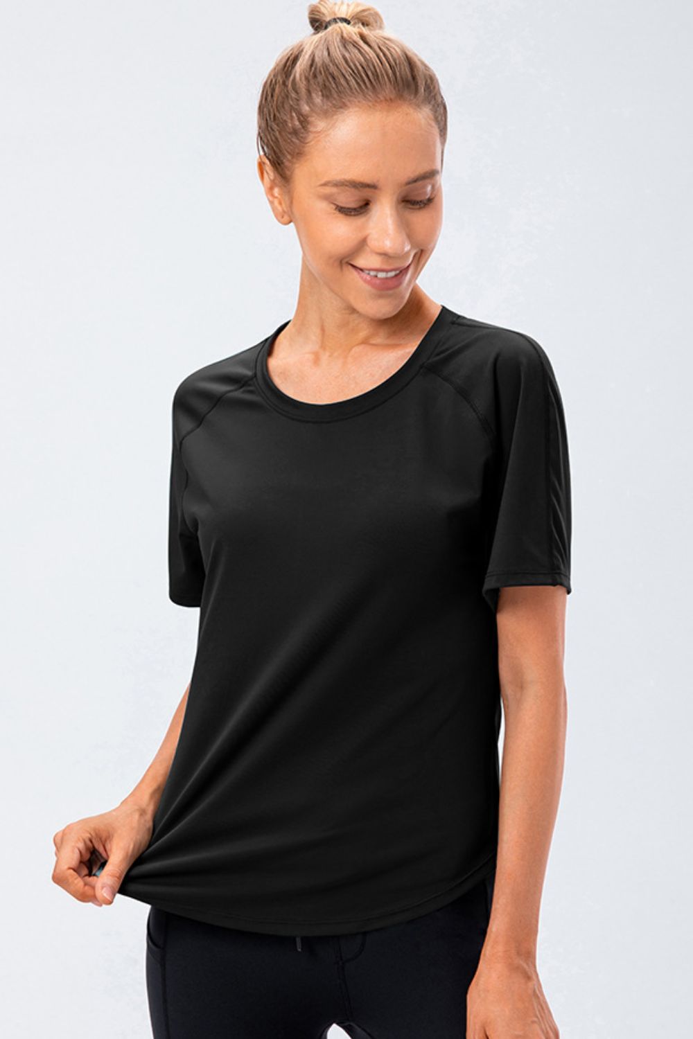 Black performance raglan crew neck tee with short sleeves