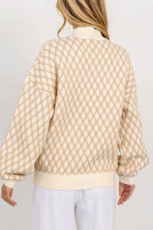 Cream diamond knit sweater with balloon sleeves and mock neck.