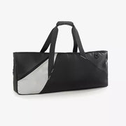 Modern color block travel bag in black with a silver panel and dual handles.
