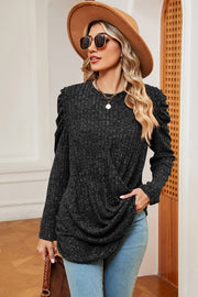 Black textured blouse with draped front and ruched sleeves