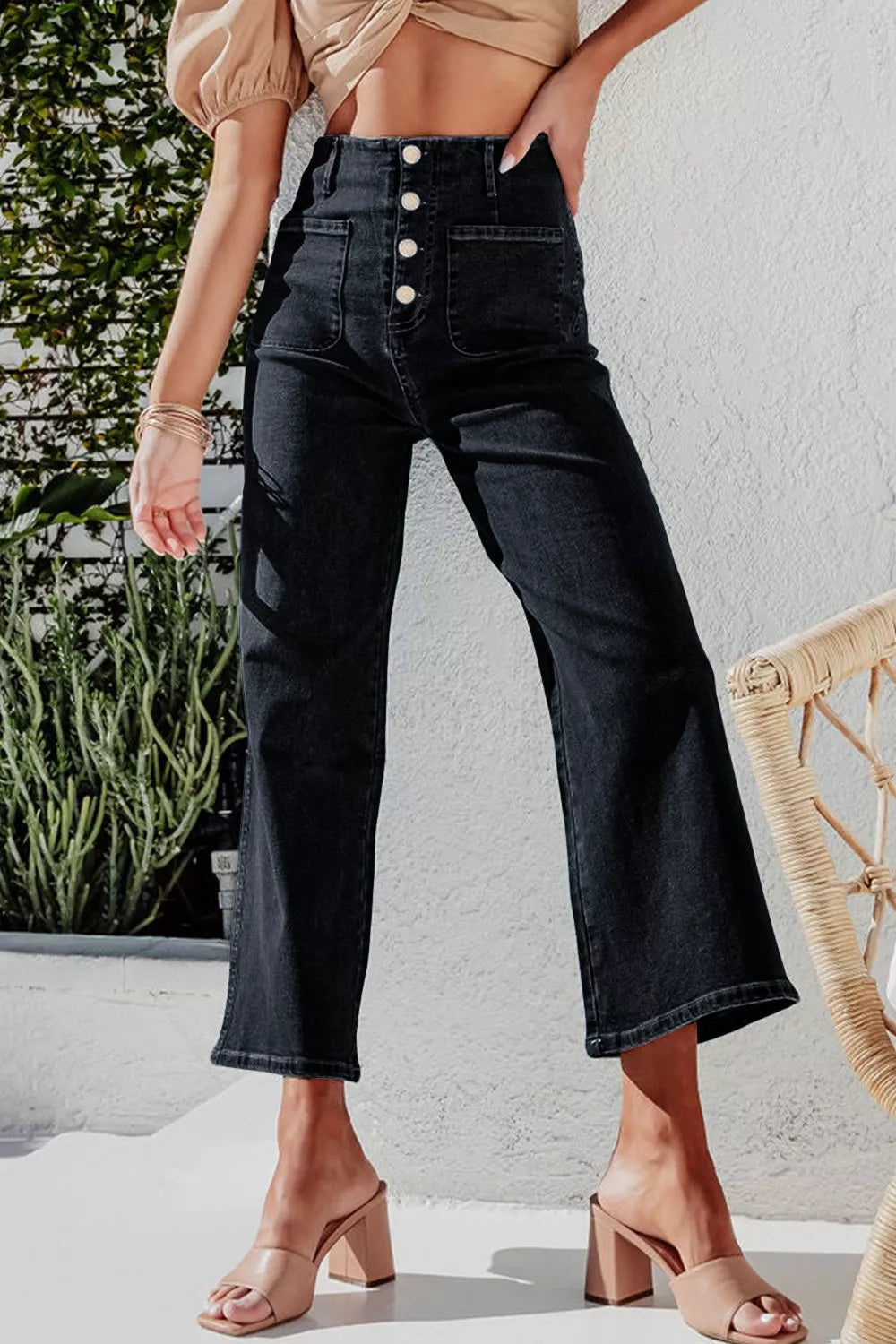 Black denim wide-leg jeans with button-fly and pocket details