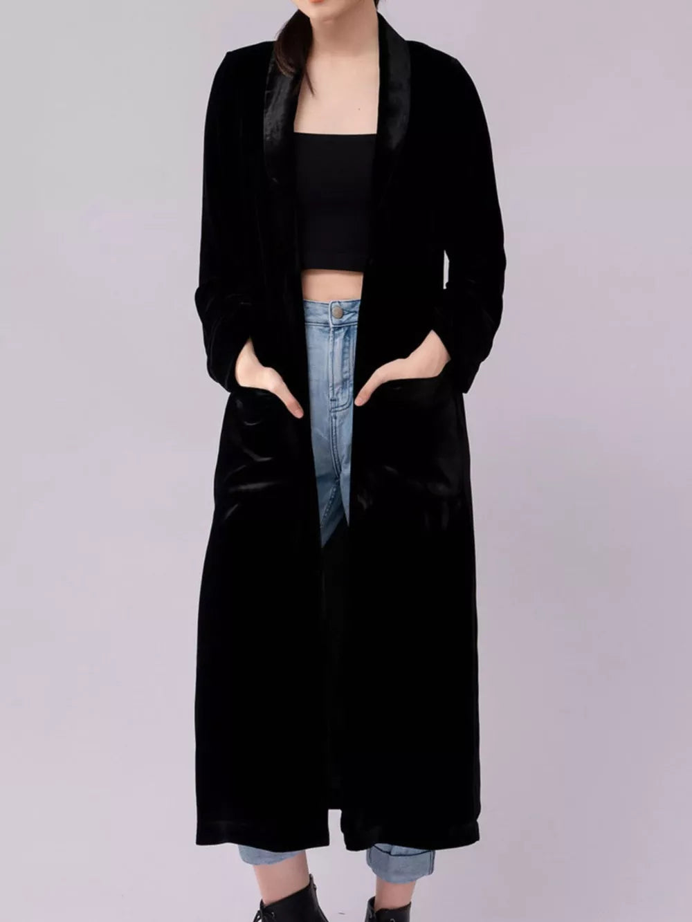 Black velvet longline trench coat with satin lapels and pockets.