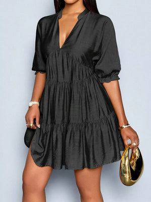 Black tiered V-neck dress with short sleeves and a ruffled hem.