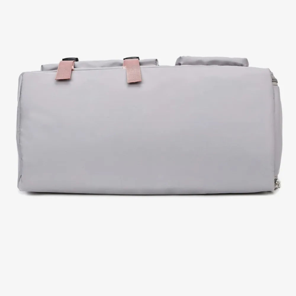 Gray duffel bag with pink buckle straps and top handles.