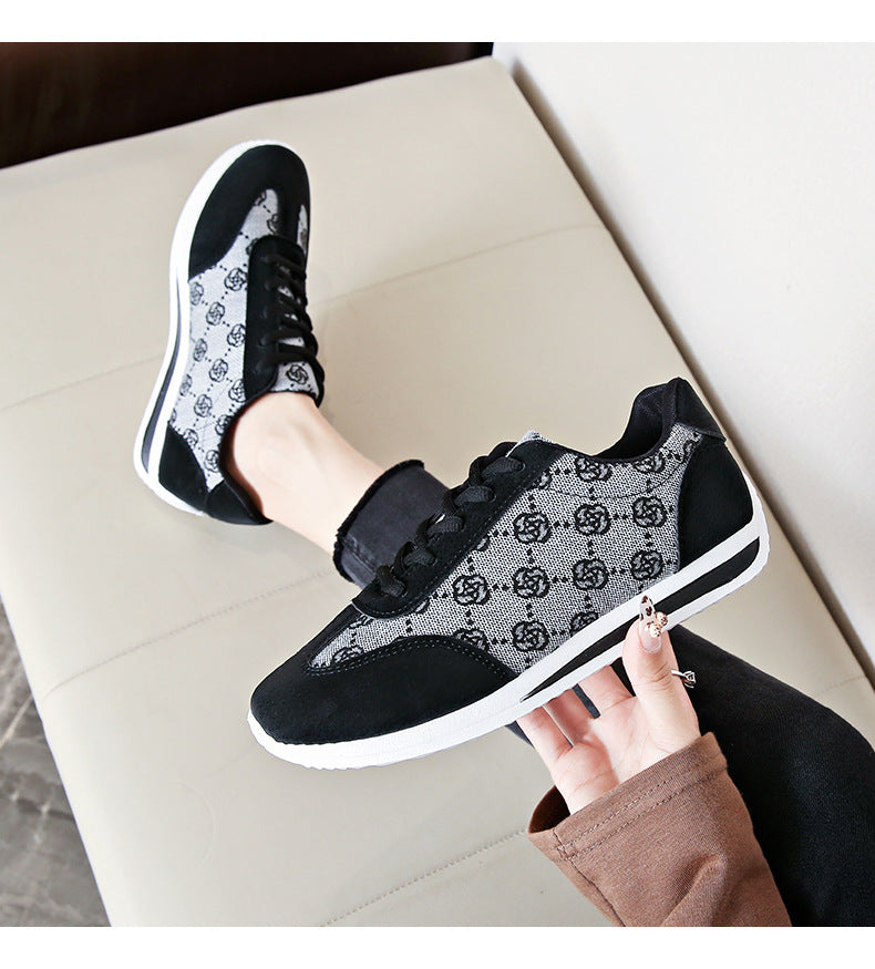 Black lace-up round toe sneakers with a patterned fabric and suede details.