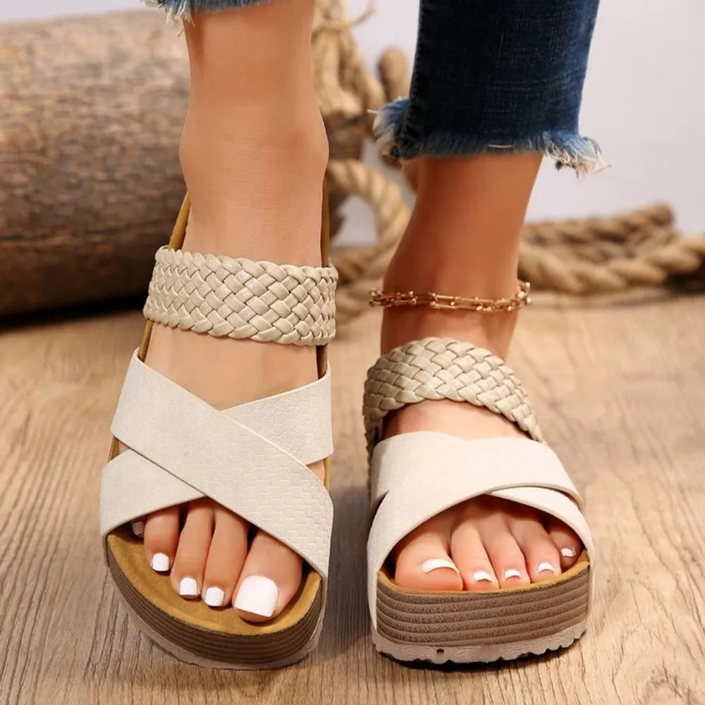 Cream braided strap platform slides with crisscross straps and a textured sole.