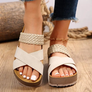 Cream braided strap platform slides with crisscross straps and a textured sole.