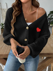 Black buttoned cardigan with balloon sleeves and red heart appliqué detail.