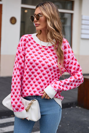Heart grid crewneck knit sweater in pink and red acrylic with white cuffs and neckline.