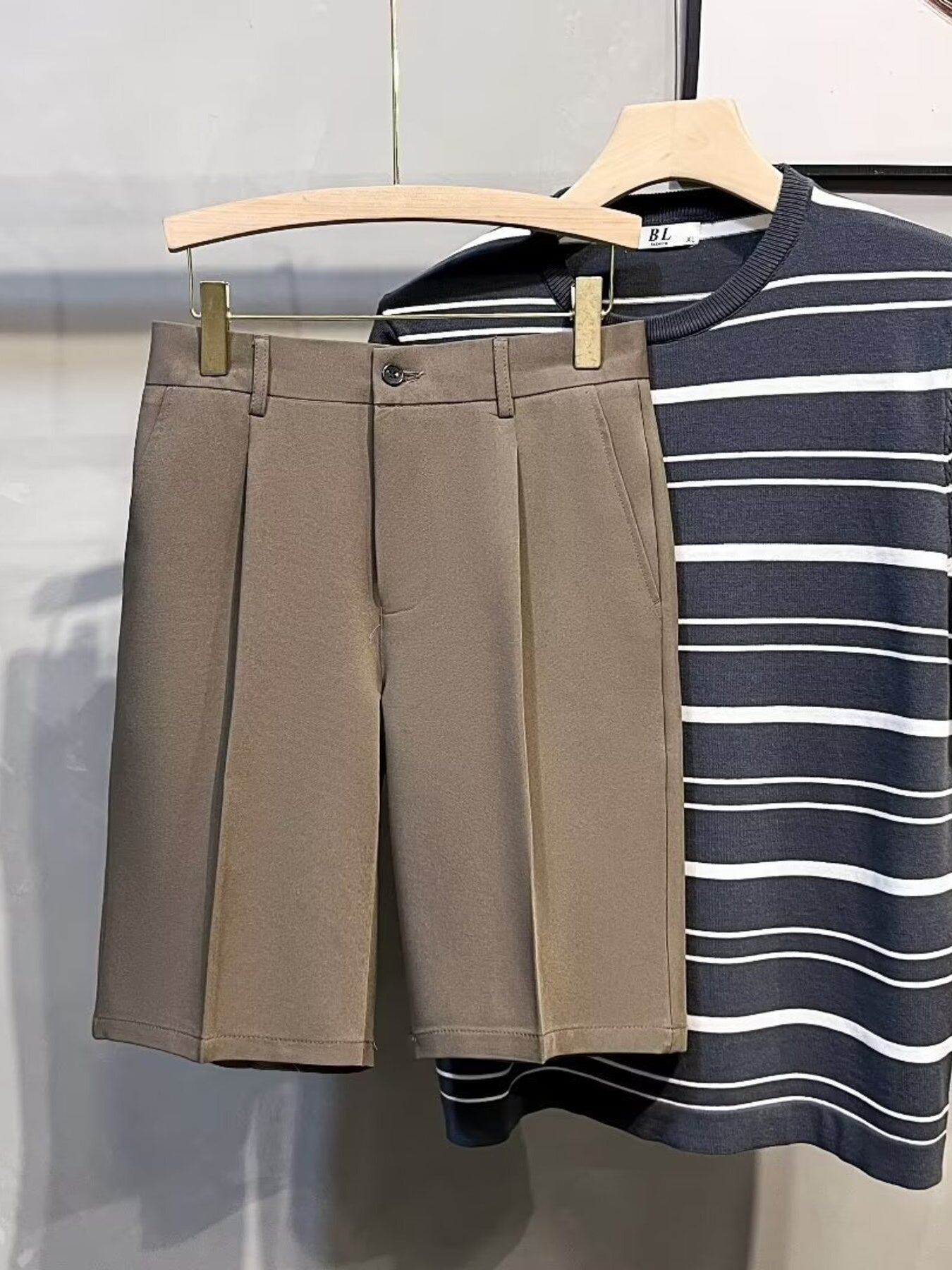 Pleated front casual men's chino shorts in mocha with a button closure and side pockets.