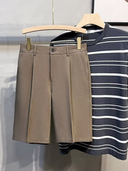 Pleated front casual men's chino shorts in mocha with a button closure and side pockets.