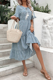 Light blue tiered midi dress with tassel detail and floral print