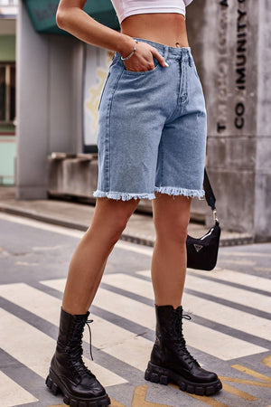 Medium wash denim bermuda shorts with frayed hem