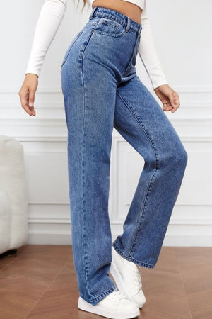 Light blue wide-leg denim jeans with a sculpted high rise, styled with white sneakers.