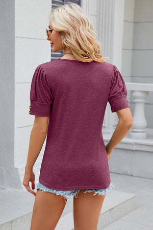 Gathered sleeve tee in Red-Violet with gold button details on the cuff.