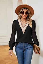 Black v-neck blouse with lace sleeves and textured trim