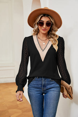 Black v-neck blouse with lace sleeves and textured trim