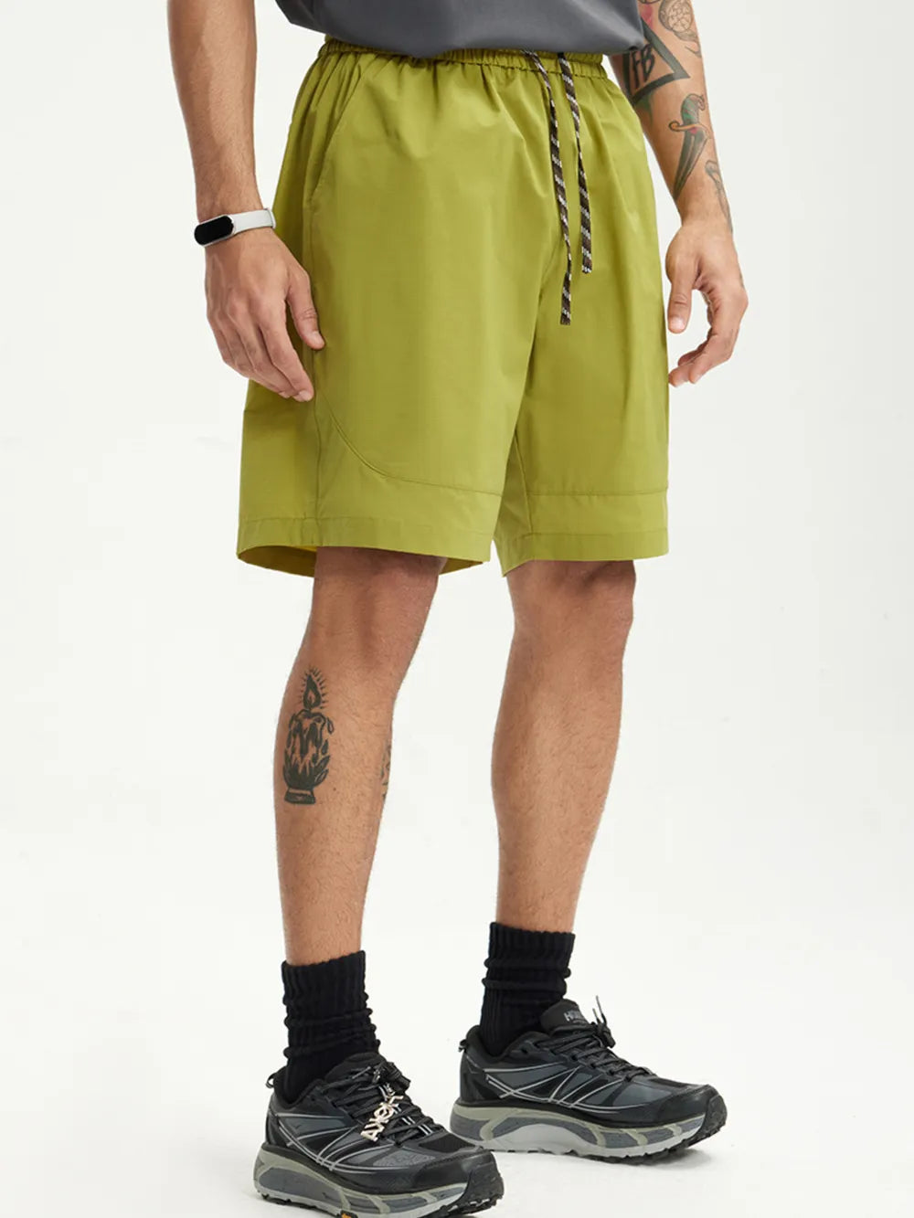 Men's olive green chino shorts with drawstring waist and pockets.