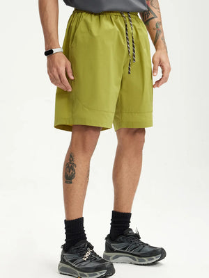 Men's olive green chino shorts with drawstring waist and pockets.