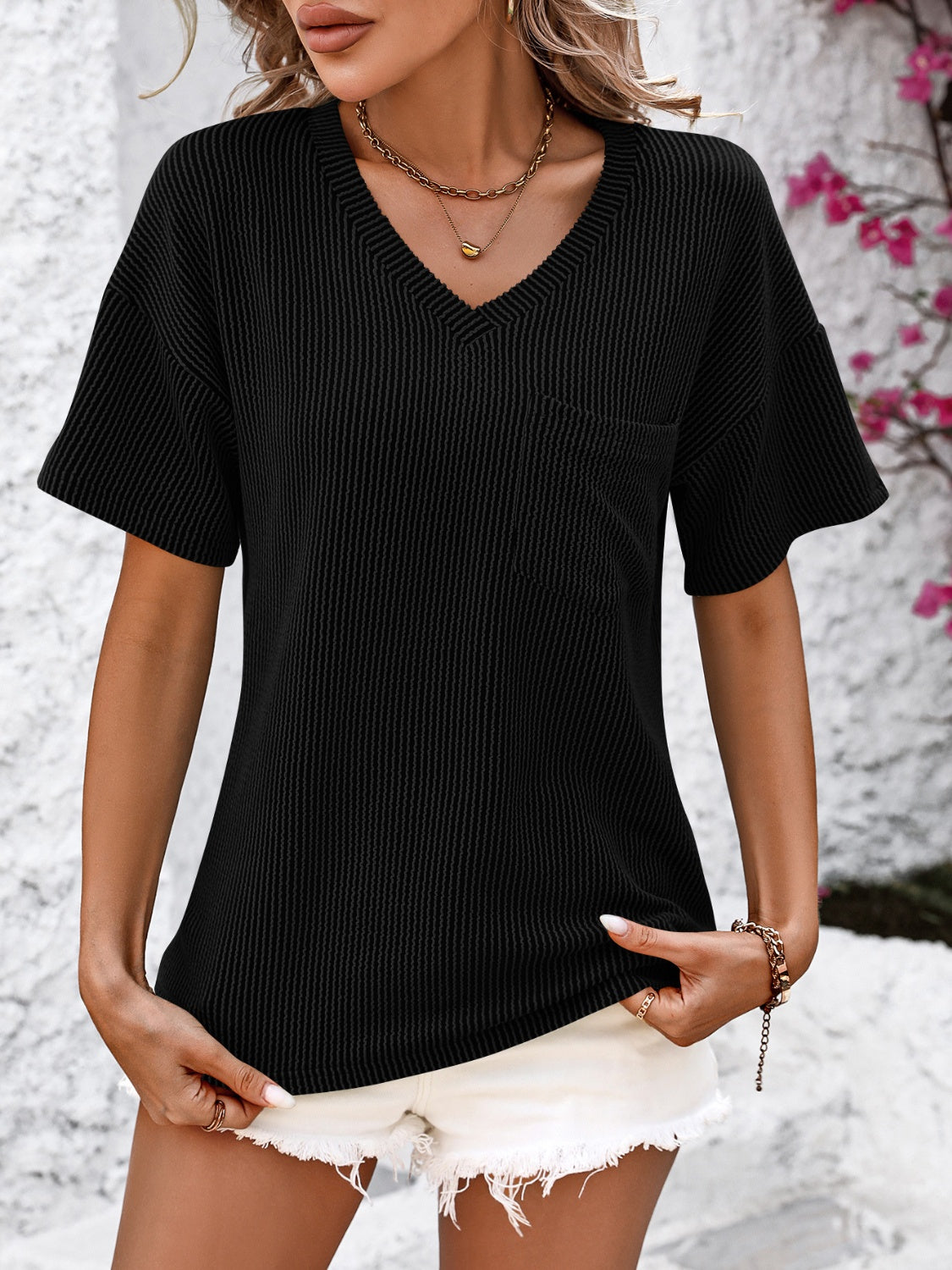 Black ribbed V-neck t-shirt with short sleeves and a chest pocket.